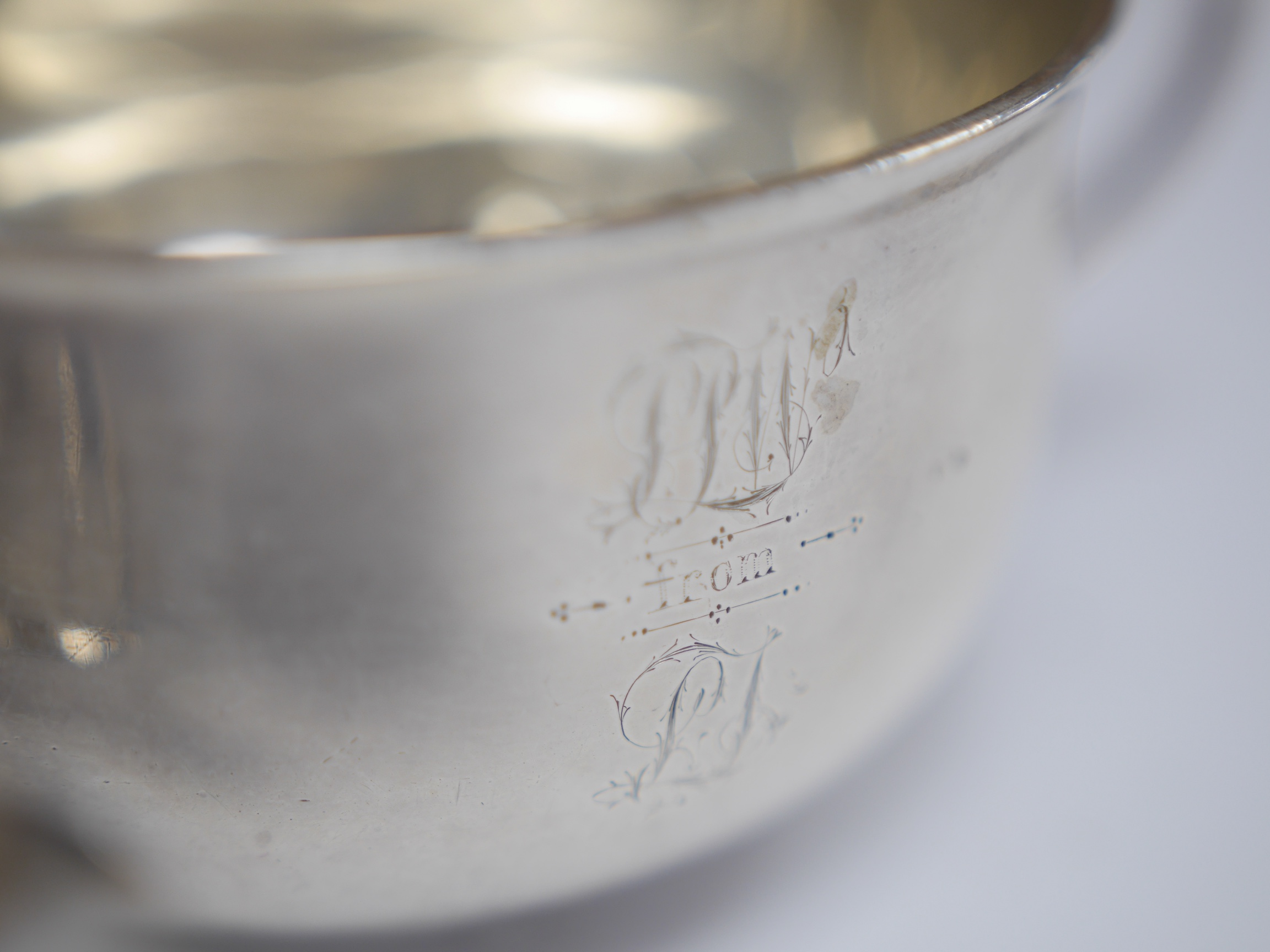 A late Victorian silver porringer, London, 1897, height 61mm, an Edwardian silver porringer, a late Victorian repousse silver sugar bowl and a George V silver cream jug by Hukin & Heath, 17.1oz. Condition - poor to fair